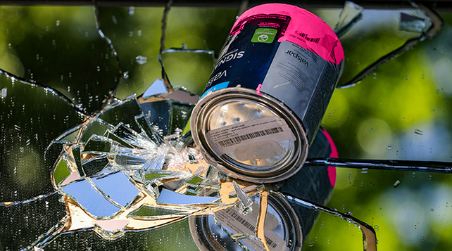 paint can fallen on top of a shattered mirror